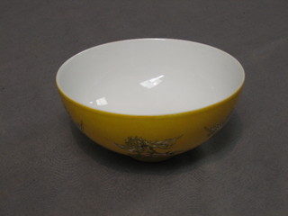 An Oriental yellow glazed porcelain bowl decorated storks, the base with 6 character mark 4"