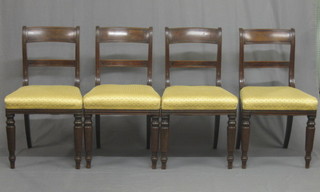 A set of 4 19th Century mahogany bar back dining chairs with plain mid rails and upholstered seat, raised on turned supports