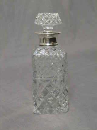 A cut glass spirit decanter and stopper with silver collar, London 1964