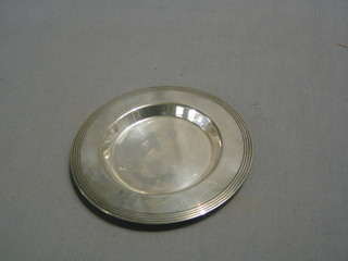 A circular silver plated patent, 5"