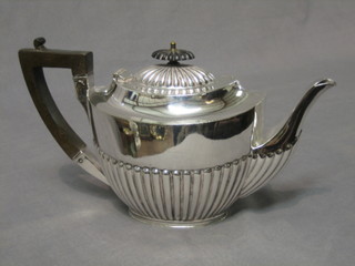 An oval silver plated teapot with demi-reeded decoration by James Dixon & Sons