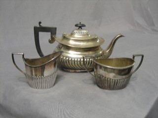 An oval silver plated 3 piece tea service with demi reeded decoration with teapot, twin handled sugar bowl and cream jug