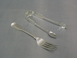A pair of Victorian Newcastle fiddle and shell pattern sugar tongs, Newcastle 1845, makers mark IS together with a fiddle pattern table fork Newcastle 1857 3 ozs