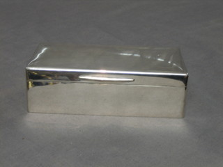 A rectangular plain silver cigarette box with hinged lid 7", rubbed