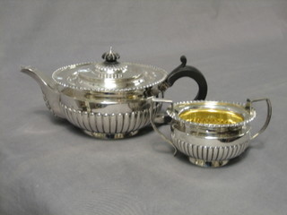 A Georgian style silver circular teapot with demi-reeded decoration and matching twin handled sugar bowl,  London 1937 by D & J Webbley 38 ozs