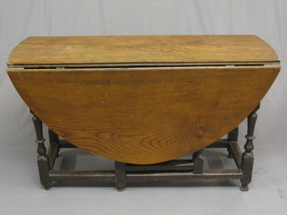 An 18th Century oak oval drop flap gateleg dining table fitted a frieze drawer and raised on turned and block supports 48"