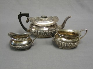A Britannia metal 3 piece tea service of oval form and demi-reeded decoration comprising teapot, twin handled sugar bowl and cream jug