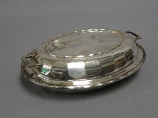 An oval twin handled silver entree dish and cover