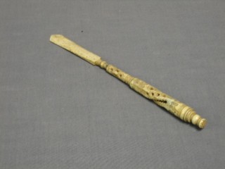 A pierced ivory dip pen incorporating a paper knife, the top with Stanhope, showing views of a Continental resort
