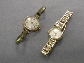 A lady's wristwatch by Audax contained in a gold case, on an integral bracelet and 1 other gold cased wristwatch (2)
