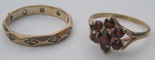 A gold eternity ring set white stones and a lady's 9ct gold dress ring set a red stone