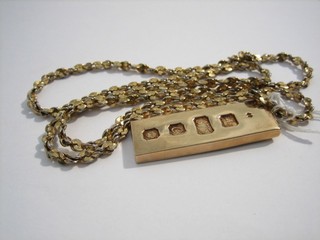 A 9ct gold ingot pendant and a gilt metal chain