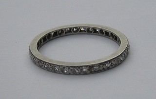An 18ct white gold or platinum full eternity ring set diamonds