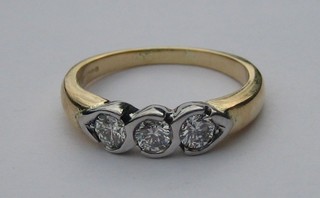 An 18ct yellow gold dress ring set 3 brilliant cut diamonds
