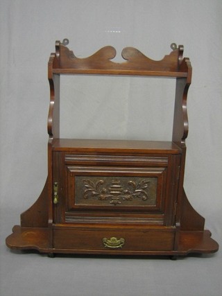 An Edwardian mahogany hanging cabinet enclosed by a panelled door, the base fitted a drawer 28"