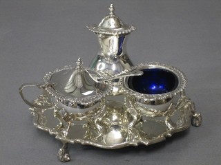 A circular silver plated salver with bracketed border, raised on scrolled feet 6" and a 3 piece Georgian style silver plated condiment set