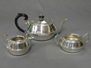 An Art Deco circular silver plated 3 piece tea service with teapot, twin handled sugar bowl and cream jug