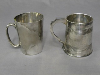 A silver plated 1 pint tankard with glass bottom and 1 other pint tankard