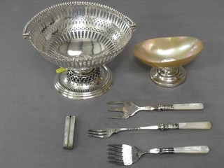 A circular pierced silver plated bon bon dish, a silver shell shaped dish, a pair of scissors with mother of pearl handles, 3 forks with m.o.p handles