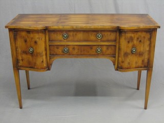 A Georgian style figured yew sideboard, fitted 2 drawers flanked by cupboards and raised on square tapering supports 51"
