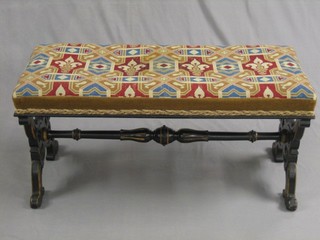 A Victorian ebonised and gilt painted Gothic style rectangular duet stool, with pierced panel supports and H framed stretcher 40"