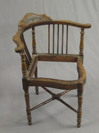 A Victorian carved walnut corner chair raised on turned supports with H framed stretcher (requires upholstery)