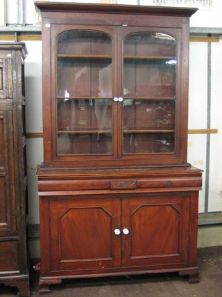A Victorian stained oak bookcase on cabinet with moulded cornice, the interior fitted adjustable shelves, the base fitted 1 long drawer enclosed by panelled doors, raised on bracket feet 51"