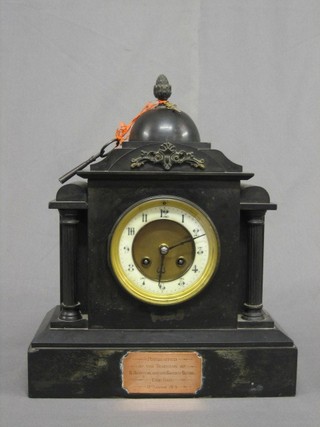 A Victorian 8 day striking mantel clock with porcelain dial and Arabic numerals contained in a black domed architectural case