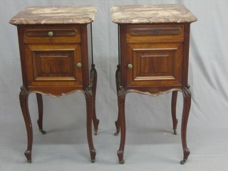A pair of French mahogany bedside cabinets with pink veined marble tops, each fitted a drawer above cupboard, raised on carved cabriole supports 18"
