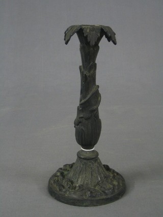 A 19th Century cast iron candlestick with leaf decoration 10"