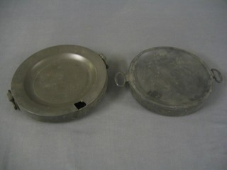 A circular pewter twin handled plate warmer, the base with touch mark 8" and 1 other