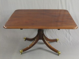 A rectangular mahogany breakfast table (split to top), raised on a gun barrel column with tripod base ending in brass caps and castors 47"