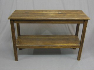 A rectangular oak 2 tier occasional table, raised on square supports 45"