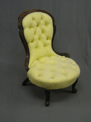 A Victorian carved walnut show frame spoon back nursing chair, raised on cabriole supports upholstered in yellow material (old break to back and missing carved crest to front cabriole supports)