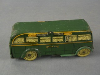 A tin plate clock work model of a Green Line Bus, marked Glasgow, Exeter, Cardiff (dent to lid and some damage)