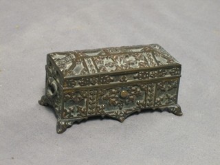 A bronze trinket box with in the form of a coffer with hinged lid, raised on bracket feet 4"