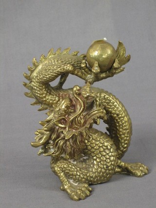 A 20th Century gilt bronze figure a seated dragon with pearl 6"