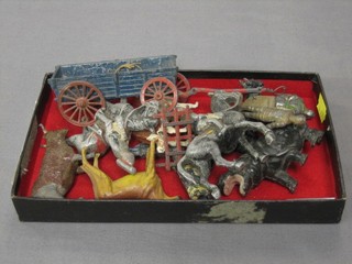 A metal model of a cart, the base marked T&B and a small collection of metal figures