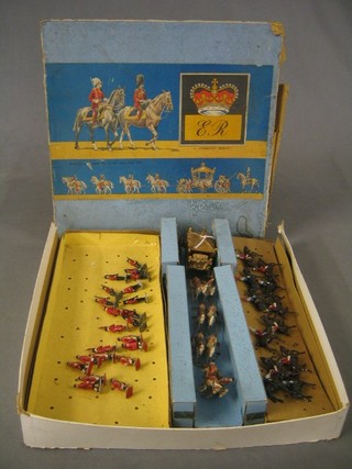 An Elizabeth II Jo Hil Co. Coronation set comprising State Coach (Queen's head f, back of coach f) and 8 riders (1 leg of horse f), 9 Postillions, mounted Equery, 11 Life Guards, 3 Yeoman of the Guard, 10 Grenadier Guards, boxed (box damaged)