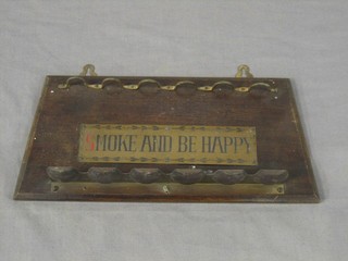 A 1930's oak and brass pipe rack, marked "Smoke and Be Happy"