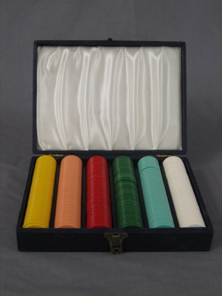 A collection of plastic game counters, cased