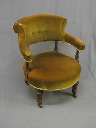 A Victorian carved walnut tub back chair upholstered in mustard coloured material