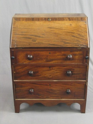 A Georgian mahogany bureau, the fall front revealing a well fitted interior with drawers and cupboard above 3 long drawers, raised on bracket feet 30"