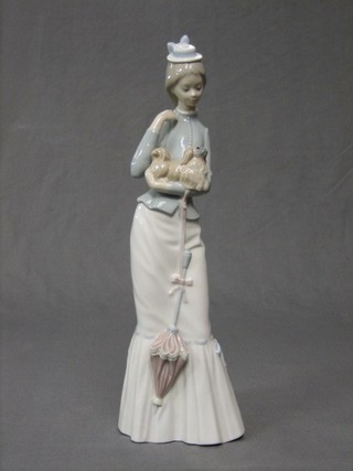 A Lladro figure of a standing lady with dog, base impressed B21 8, 14"