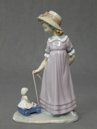 A Lladro figure of a standing bonnetted girl with pull along cart, the base impressed 5044, 11"