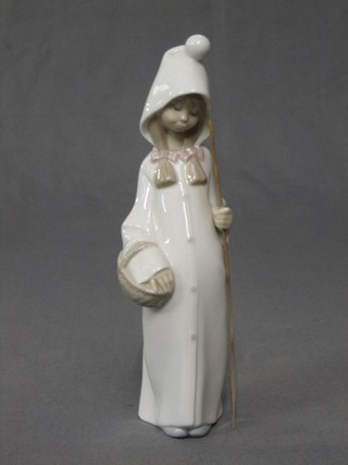 A Lladro figure of a standing bonnetted girl with basket and willow stick, the base impressed 4678 8 1/2"