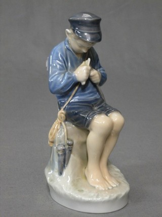 A Royal Copenhagen figure of a seated boy fisherman, base marked 905, 7 1/2"