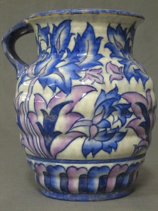 A Charlotte Rhead Crown Ducal jug with blue stylised floral decoration, the base marked Crown Ducal, Made in England and signed Charlotte Rhead A207, 8" (star crack to the base)