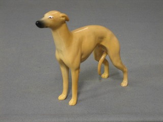 A Beswick figure of  a standing sand coloured whippet/greyhound, (paw marked 12), 5"