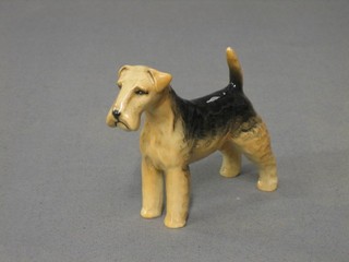 A Beswick figure of a standing Airedale Terrier (paw marked 7) 3"